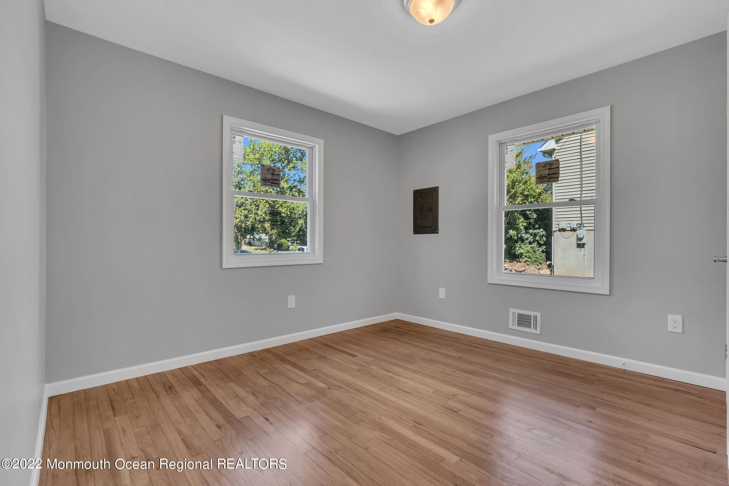 115 West 5th Street Howell, NJ 07731 - Photo 11 of 28 a view of an empty room with wooden floor and a window