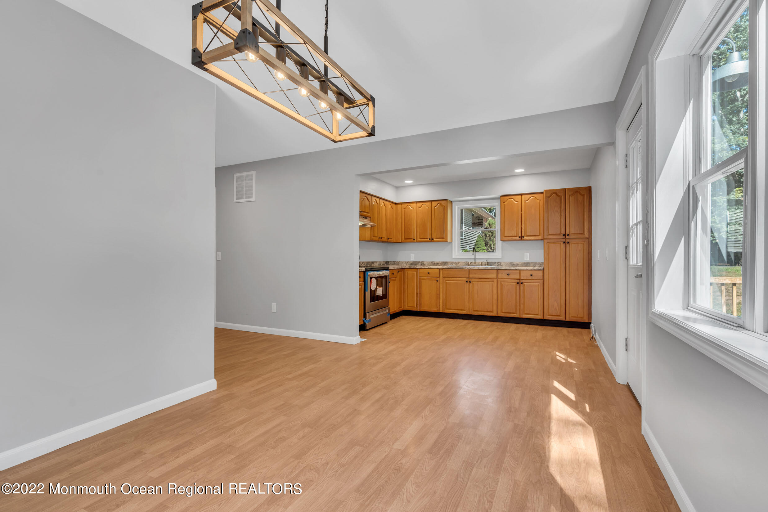 115 West 5th Street Howell, NJ 07731 - Photo 18 of 28 a view of an empty room with a window and wooden floor