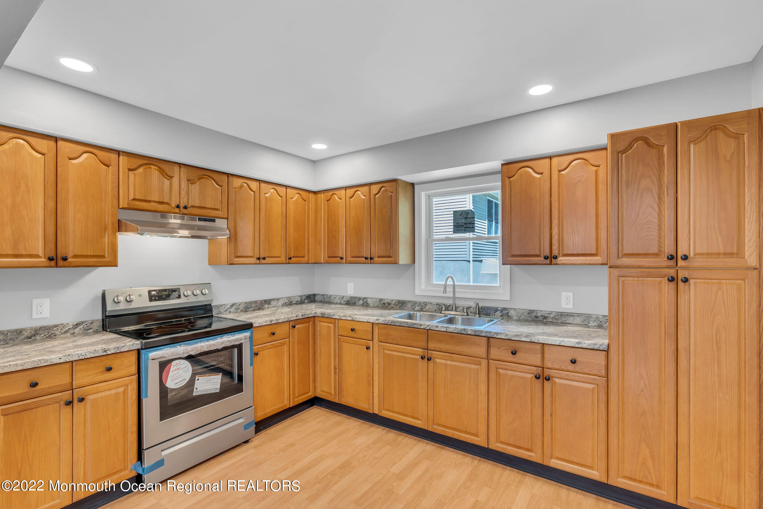 115 West 5th Street Howell, NJ 07731 - Photo 19 of 28 a kitchen with granite countertop wooden cabinets stainless steel appliances and a sink