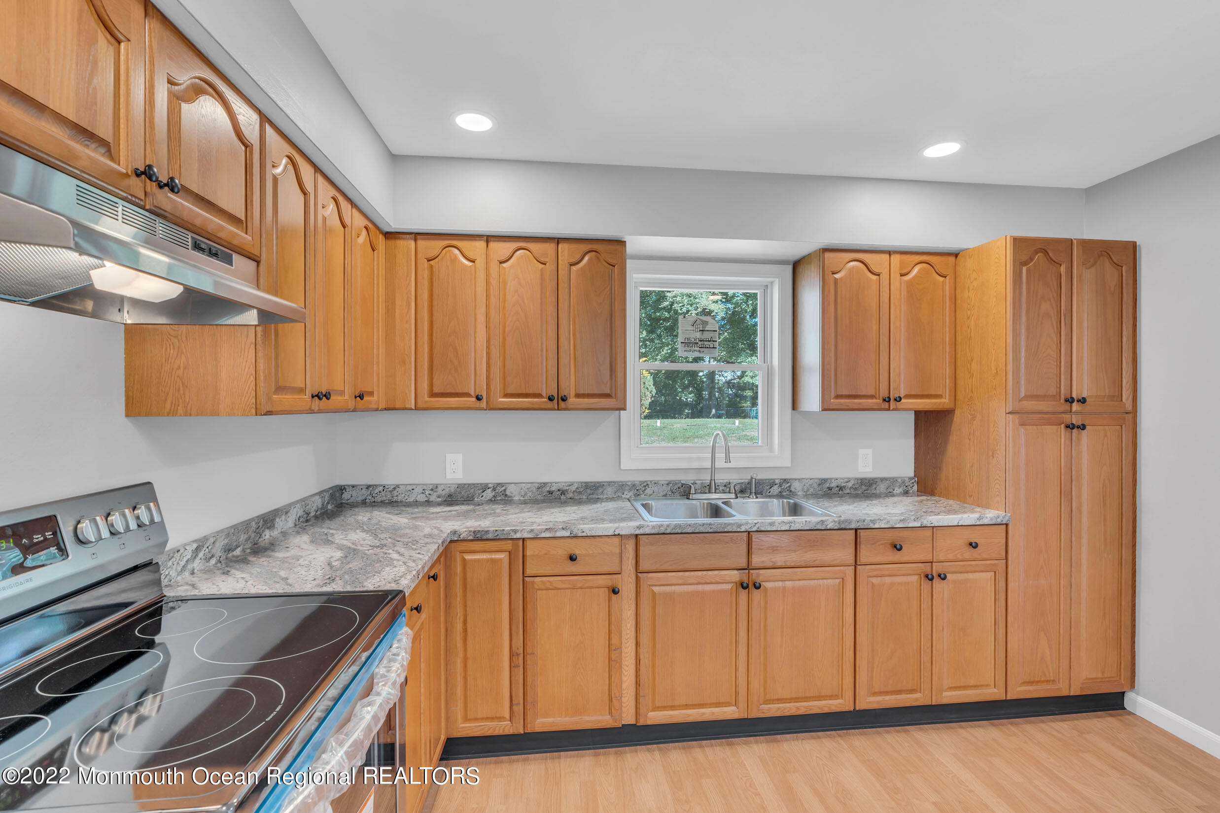 115 West 5th Street Howell, NJ 07731 - Photo 20 of 28 a kitchen with wooden cabinets and sink