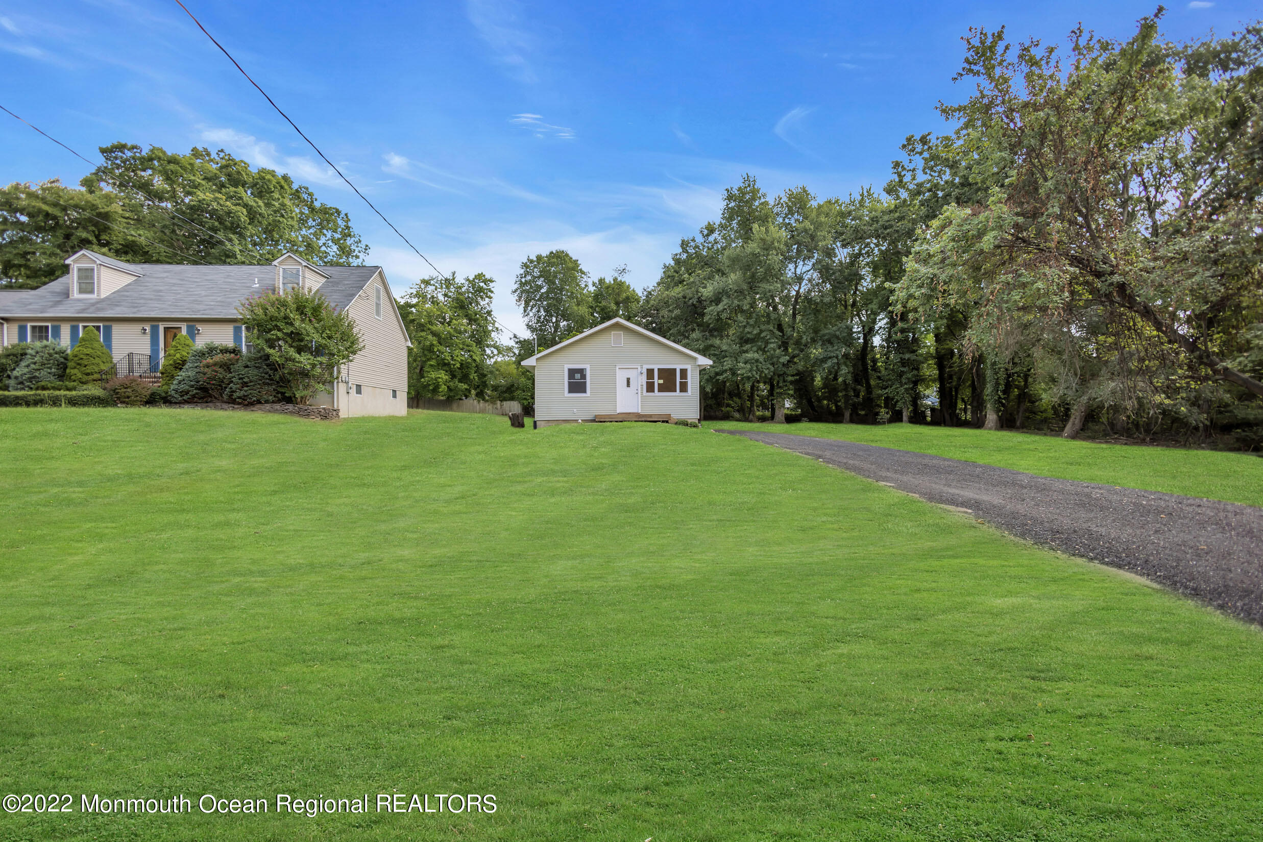 115 West 5th Street Howell, NJ 07731 - Photo 2 of 28 a view of a big house with a big yard and large trees