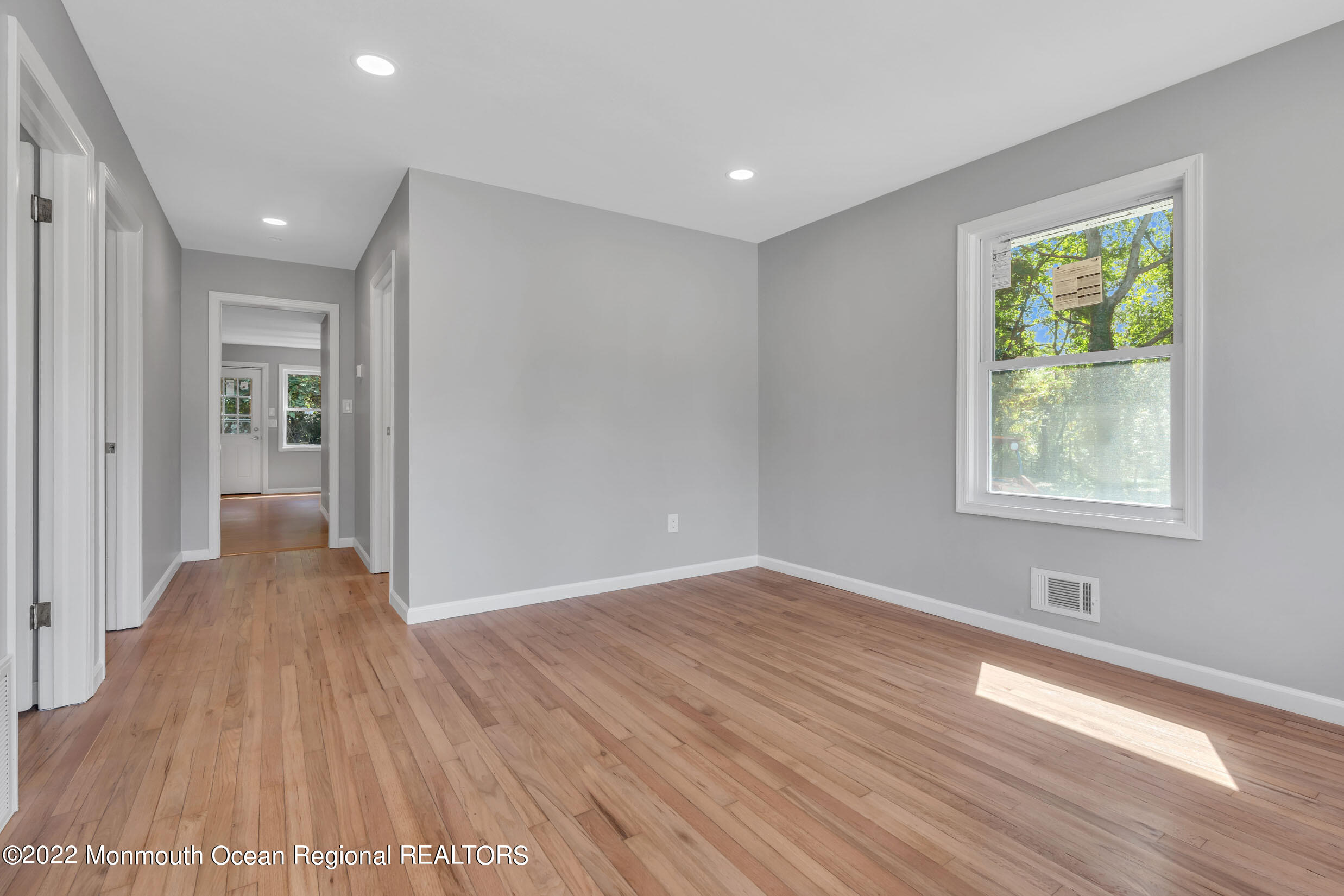 115 West 5th Street Howell, NJ 07731 - Photo 6 of 28 a view of an empty room with wooden floor and a window