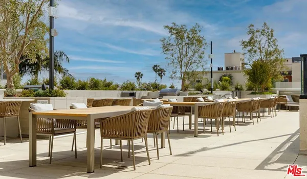 a view of a patio with dining table and chairs