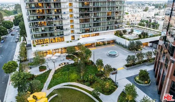 an aerial view of a house with swimming pool and outdoor seating