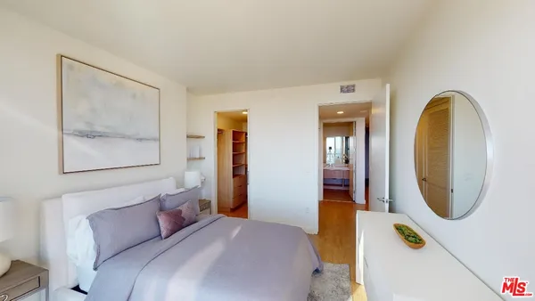 a bedroom with a bed and a mirror