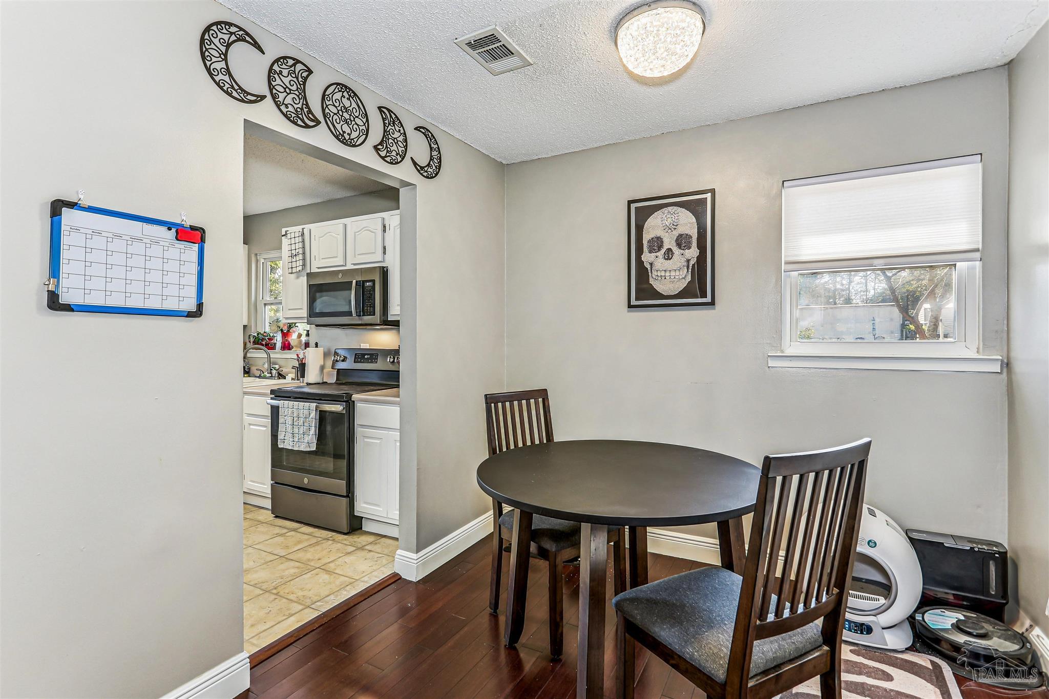 6810 Myra Road Molino, FL 32577 - Photo 16 of 20 a kitchen with stainless steel appliances granite countertop a sink and a refrigerator