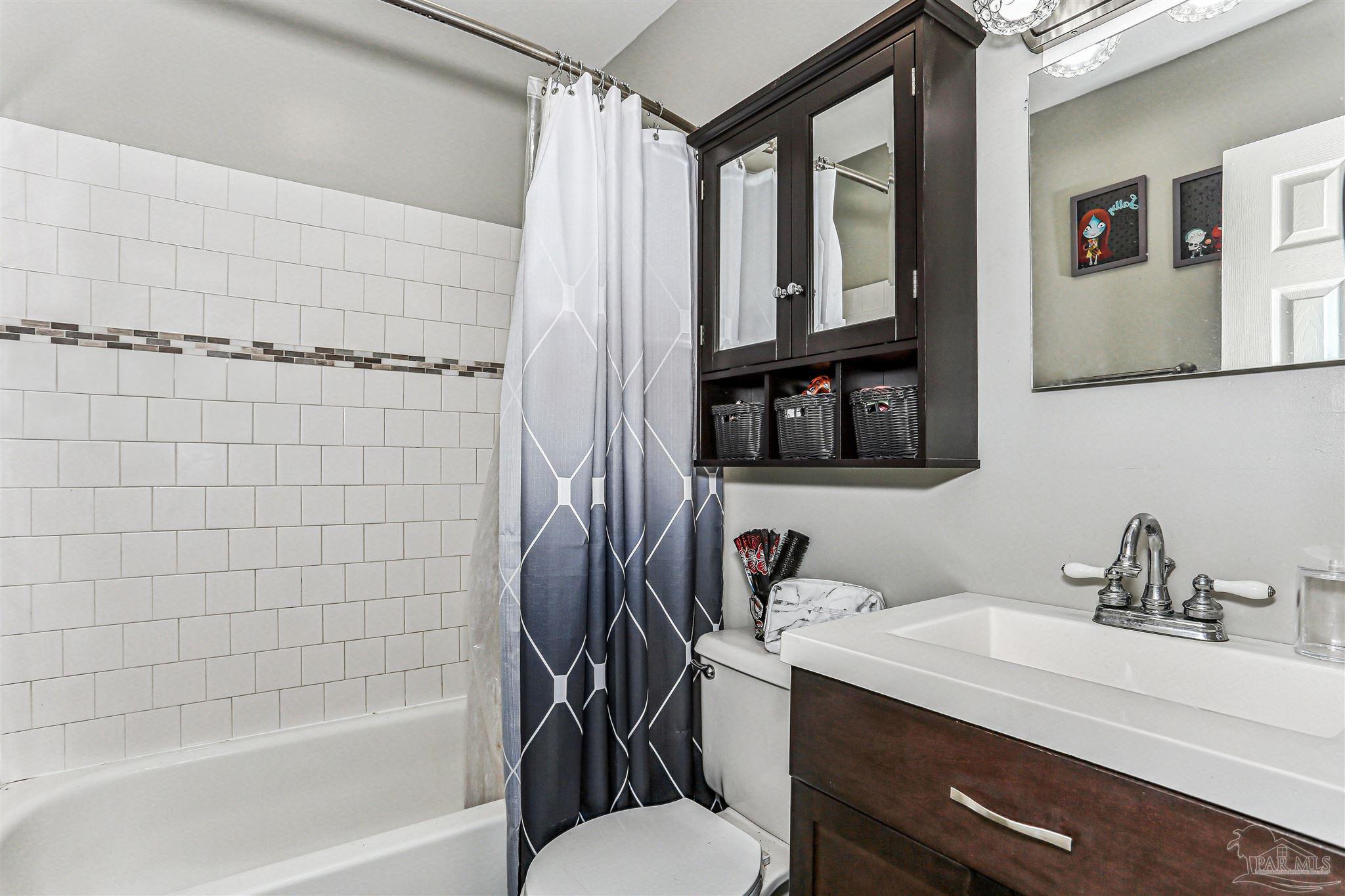 6810 Myra Road Molino, FL 32577 - Photo 18 of 20 a bathroom with a granite countertop sink toilet and shower