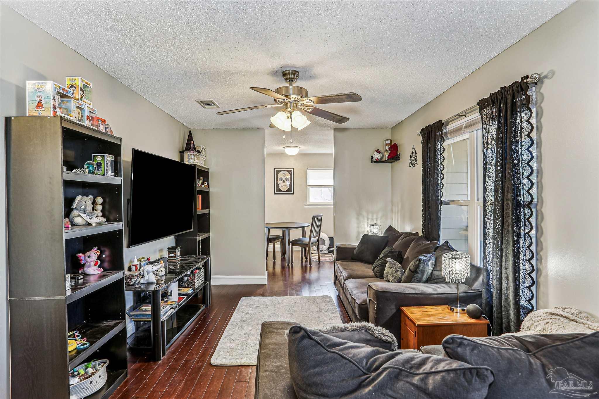 6810 Myra Road Molino, FL 32577 - Photo 9 of 20 a living room with furniture and a flat screen tv