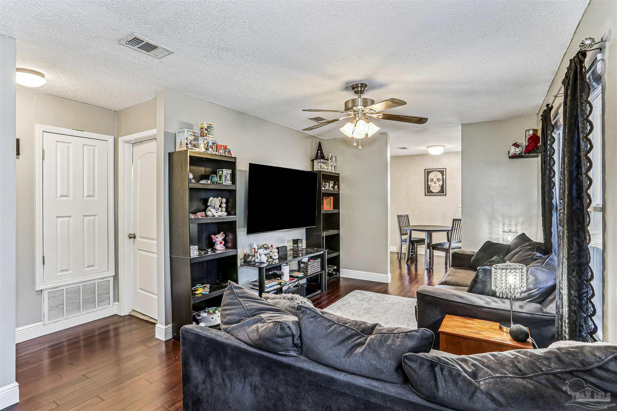 6810 Myra Road Molino, FL 32577 - Photo 10 of 20 a living room with furniture and a flat screen tv