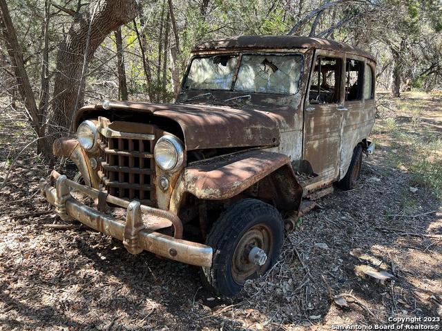 235 West Cambridge Road Wimberley, TX 78676 - Photo 17 of 27 a view of a house with backyard