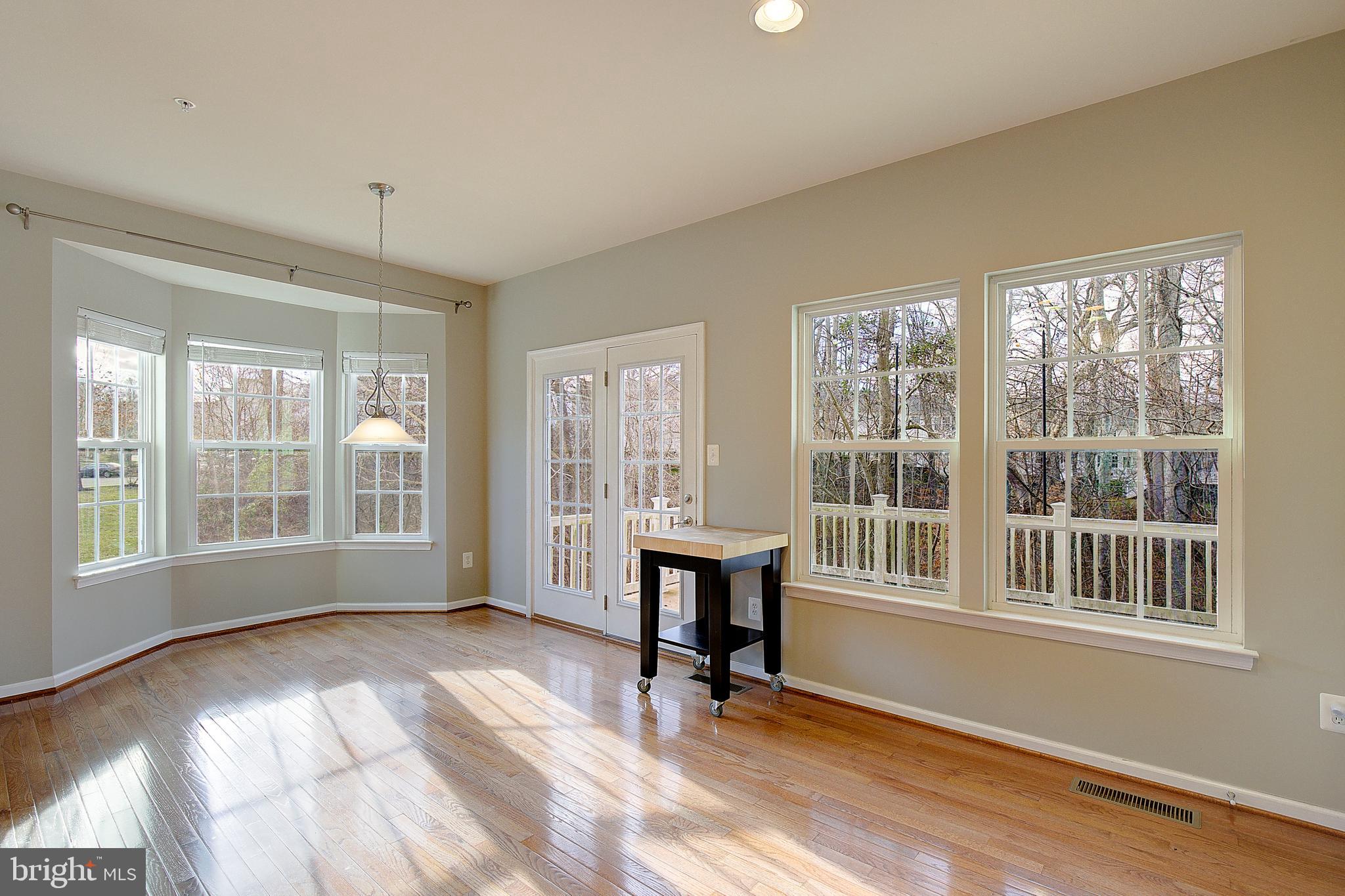 8410 Clear Spring Drive, Unit 1 Chesapeake Beach, MD 20732 - Photo 14 of 41 a view of an empty room with a window and wooden floor