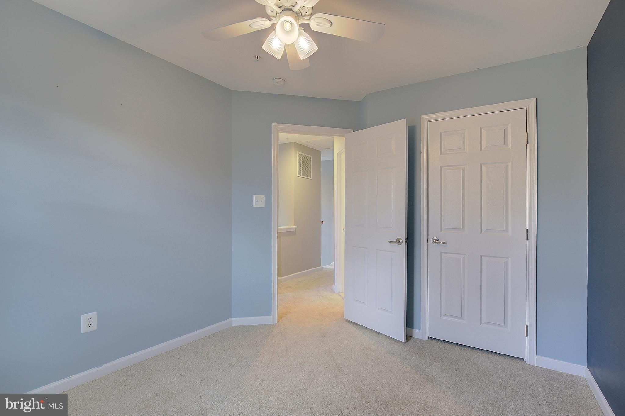 8410 Clear Spring Drive, Unit 1 Chesapeake Beach, MD 20732 - Photo 16 of 41 a view of an empty room and chandelier fan