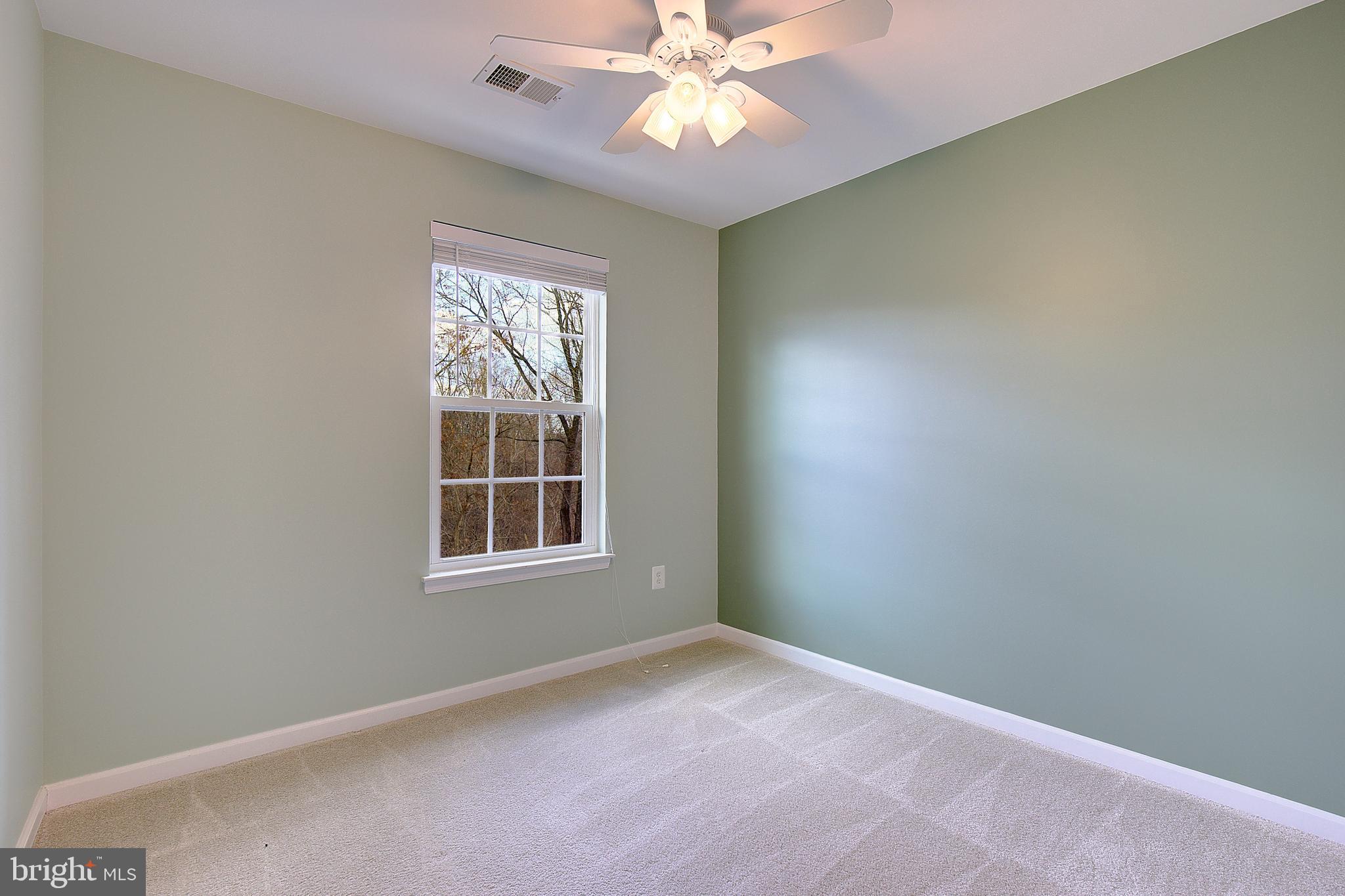 8410 Clear Spring Drive, Unit 1 Chesapeake Beach, MD 20732 - Photo 17 of 41 an empty room with a window and a fan