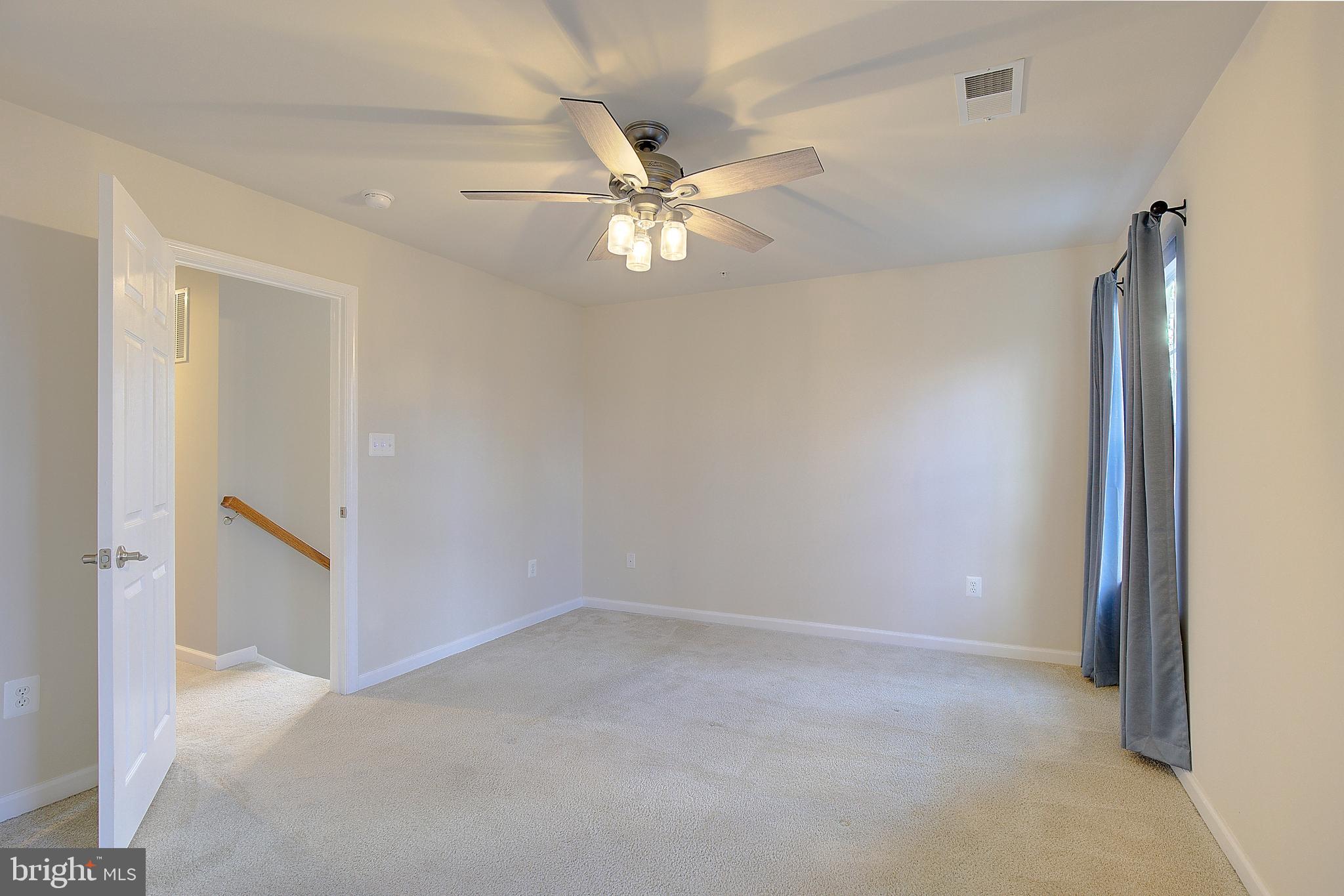 8410 Clear Spring Drive, Unit 1 Chesapeake Beach, MD 20732 - Photo 24 of 41 a view of an empty room with a ceiling fan