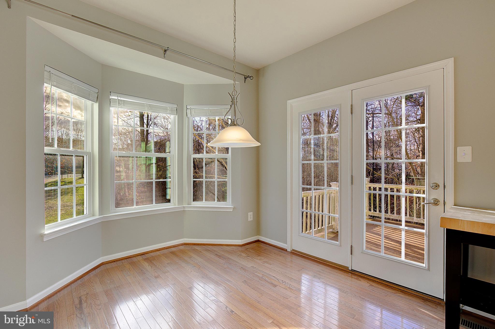 8410 Clear Spring Drive, Unit 1 Chesapeake Beach, MD 20732 - Photo 27 of 41 a view of an empty room with a window and wooden floor