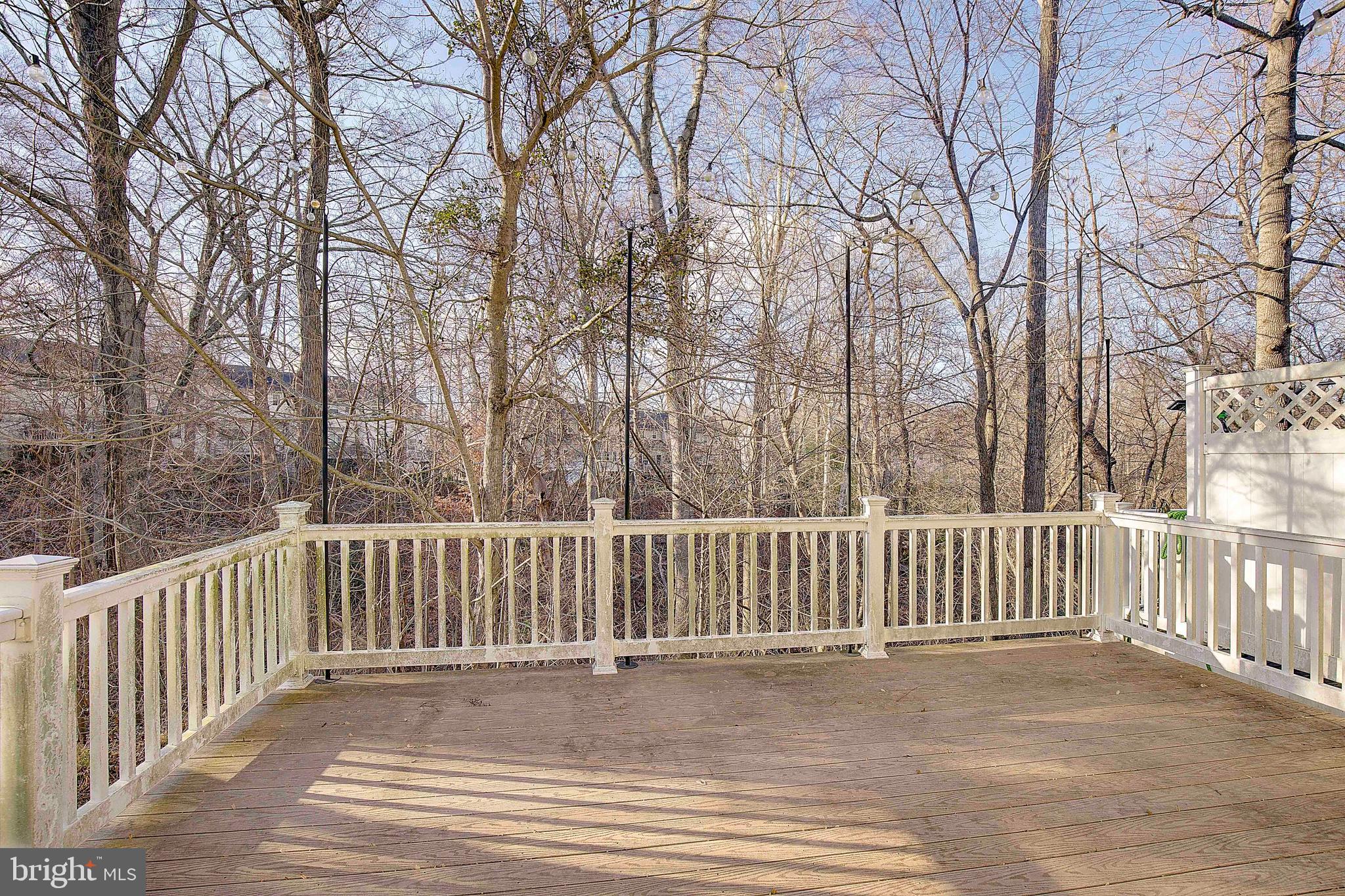 8410 Clear Spring Drive, Unit 1 Chesapeake Beach, MD 20732 - Photo 34 of 41 a view of a roof deck with wooden fence and trees