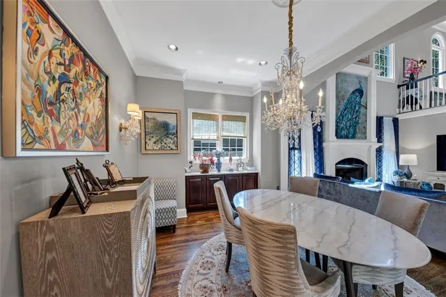 a kitchen with stainless steel appliances kitchen island granite countertop a sink dishwasher and a stove with wooden floor