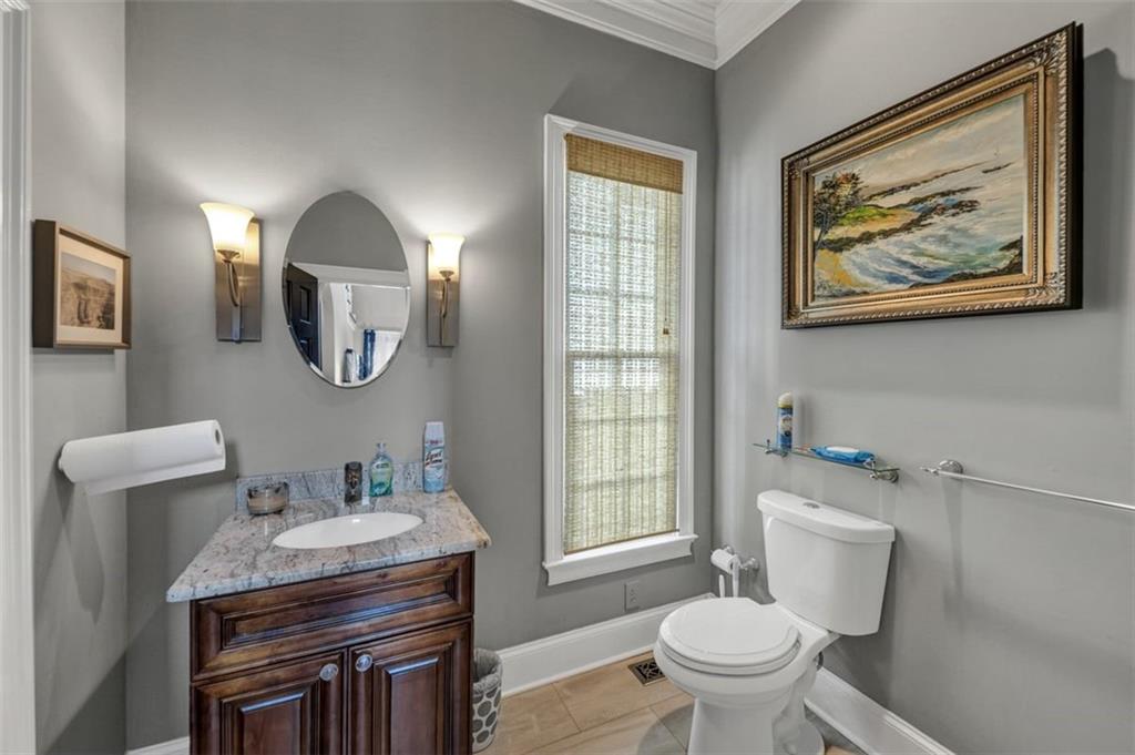526 Hill Street Southeast Atlanta, GA 30312 - Photo 23 of 81 a bathroom with a toilet a sink and mirror