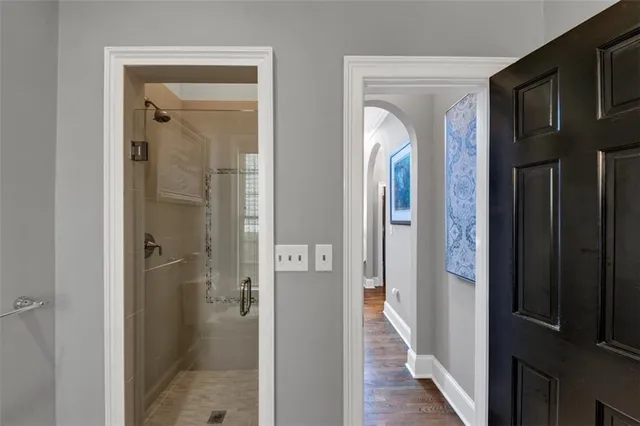 a spacious bathroom with a double vanity sink a large mirror a bathtub and window
