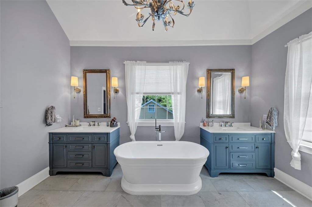 526 Hill Street Southeast Atlanta, GA 30312 - Photo 38 of 81 a spacious bathroom with a double vanity sink a large mirror a bathtub and window