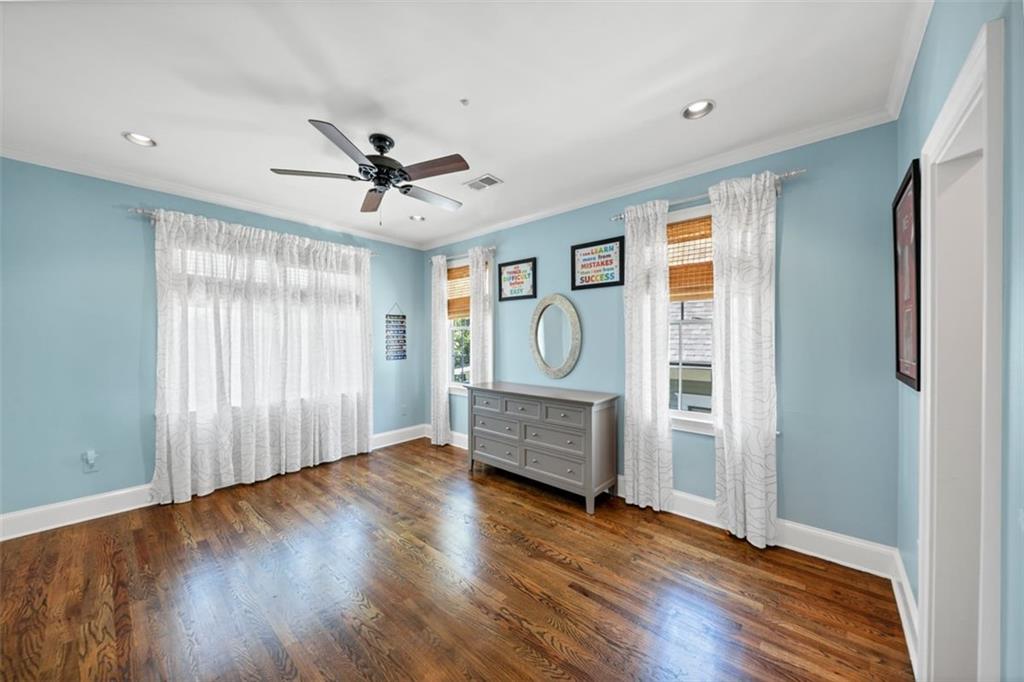 526 Hill Street Southeast Atlanta, GA 30312 - Photo 45 of 81 an empty room with wooden floor chandelier fan and windows