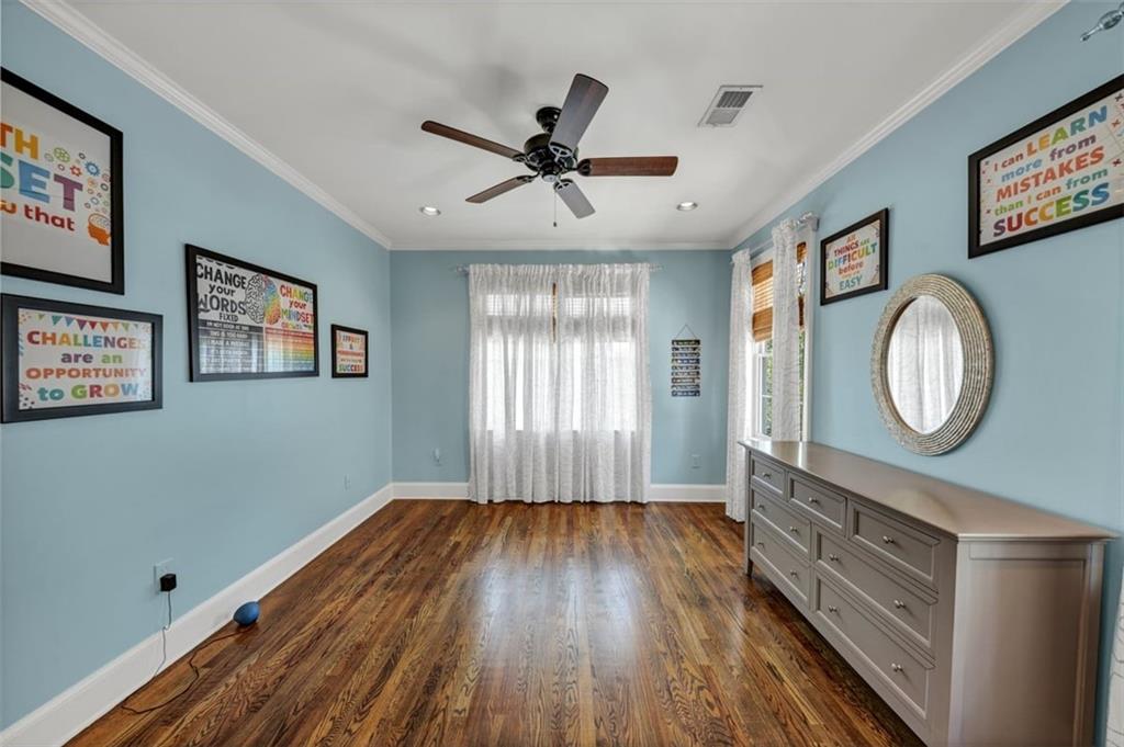526 Hill Street Southeast Atlanta, GA 30312 - Photo 46 of 81 a view of a room with wooden floor window and a ceiling fan