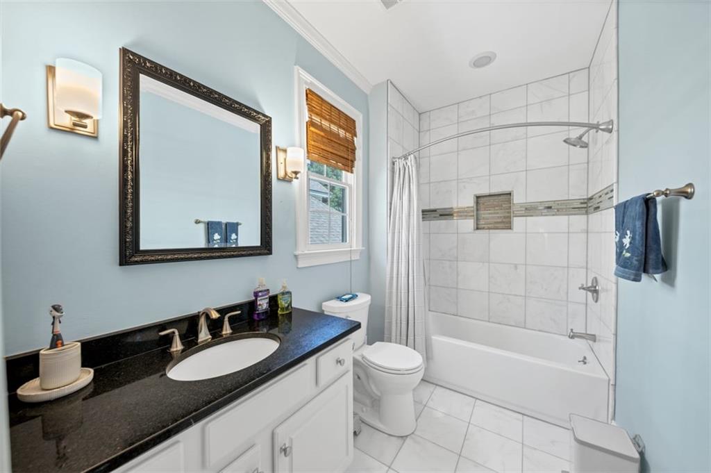 526 Hill Street Southeast Atlanta, GA 30312 - Photo 48 of 81 a bathroom with a granite countertop sink mirror toilet and bathtub
