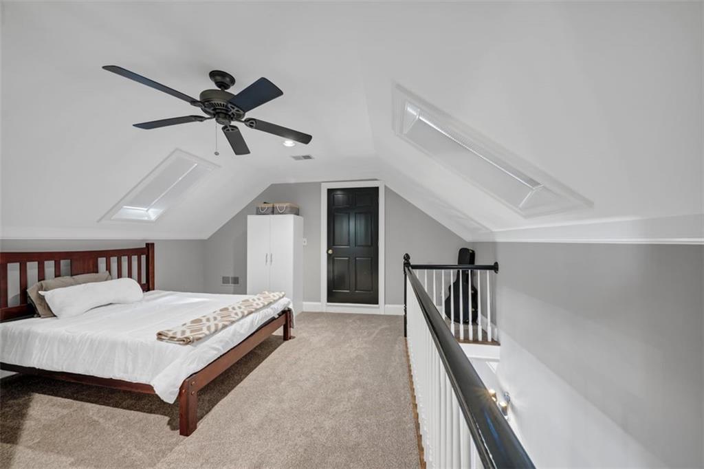 526 Hill Street Southeast Atlanta, GA 30312 - Photo 49 of 81 a bedroom with a bed and a chandelier