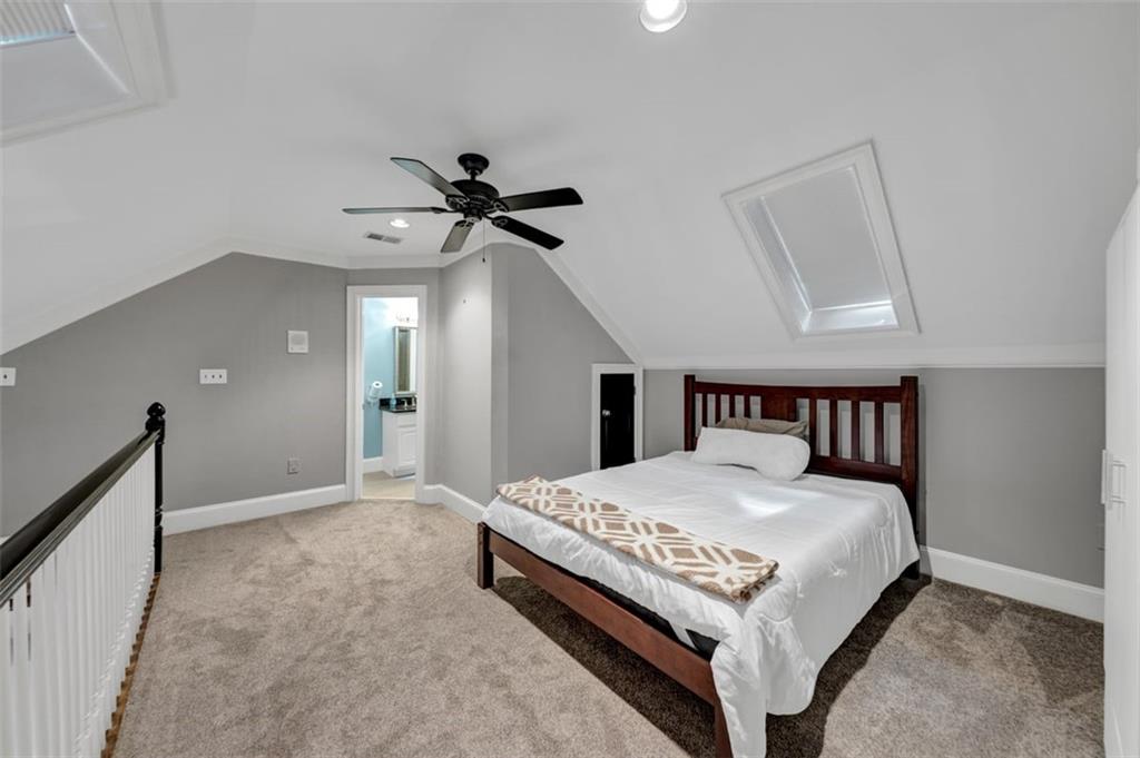 526 Hill Street Southeast Atlanta, GA 30312 - Photo 50 of 81 a large bedroom with a bed and a chandelier