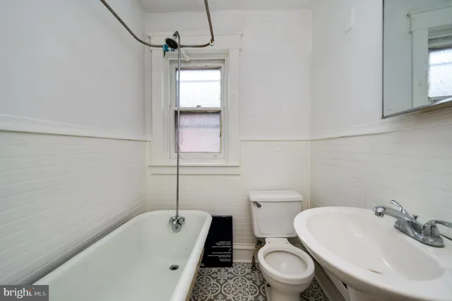 a bathroom with a sink a toilet and a tub