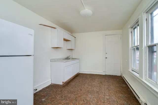 a view of a kitchen with a sink and dishwasher stove top oven