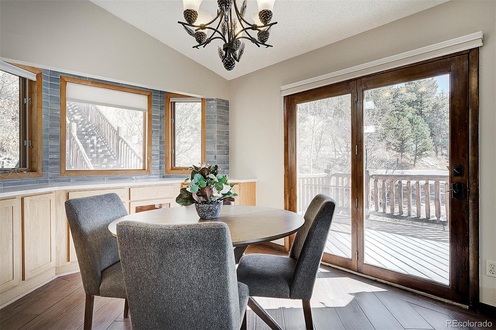 6561 Ridgeview Drive Morrison, CO 80465 - Photo 7 of 36 a view of a dining room with furniture window and wooden floor