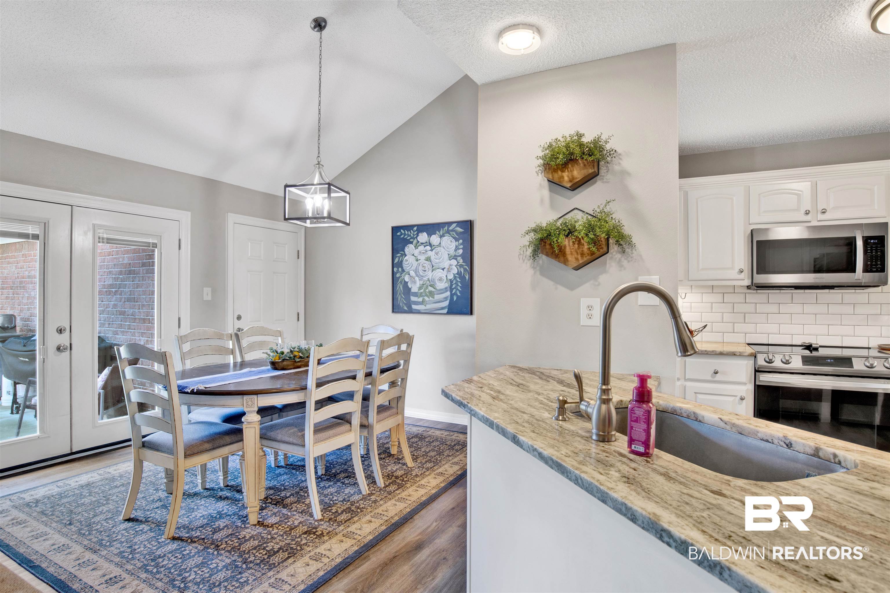 17483 East View Loop Foley, AL 36535 - Photo 14 of 30 Kitchen with pendant lighting, stainless steel appliances, sink, french doors, and white cabinets