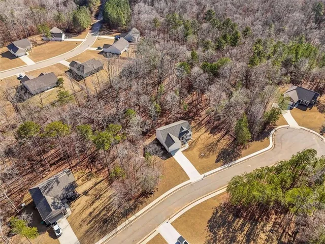 an aerial view of residential houses with outdoor space