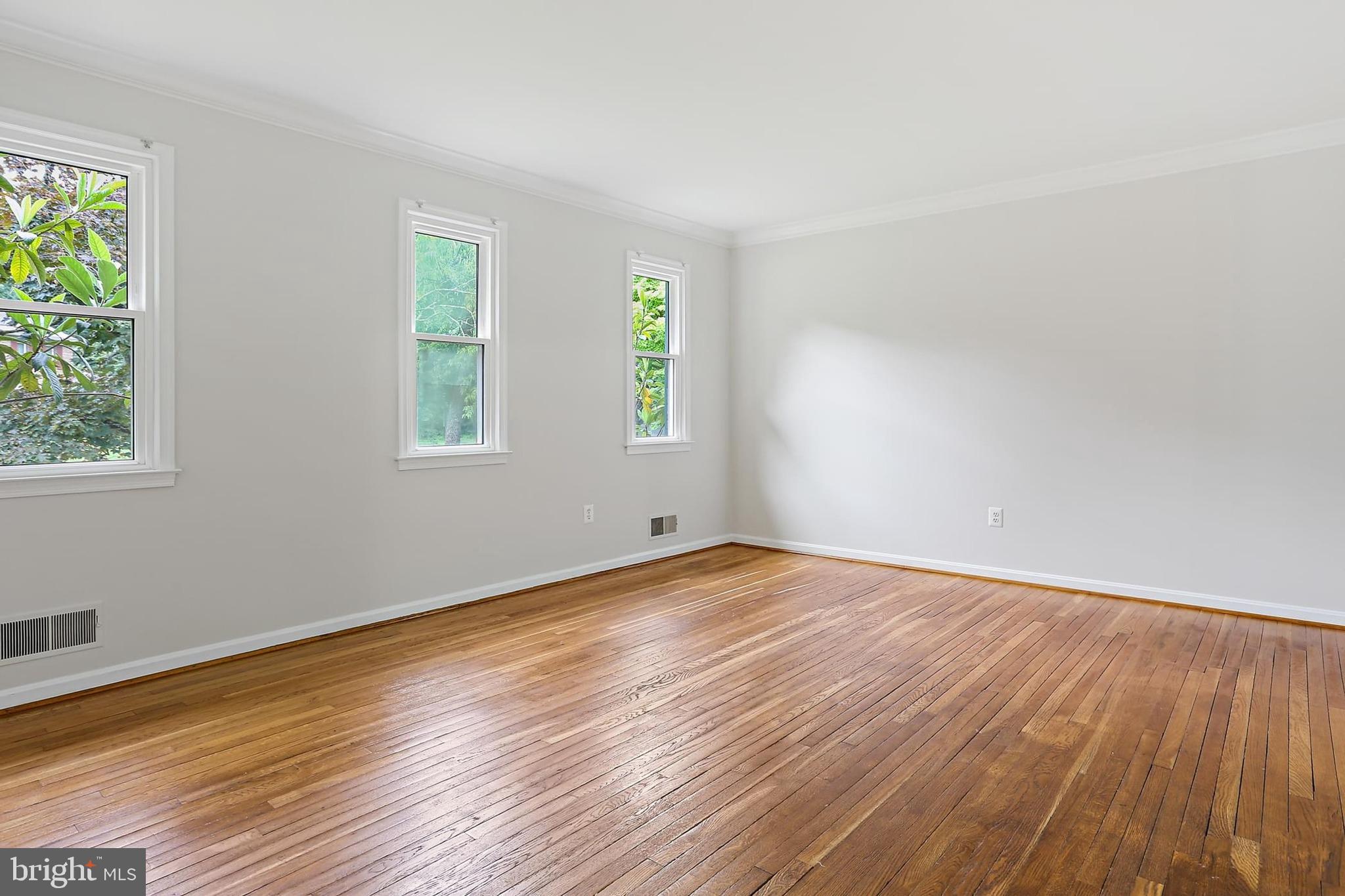 15504 Williston Road Silver Spring, MD 20905 - Photo 13 of 41 a view of an empty room with wooden floor and a window