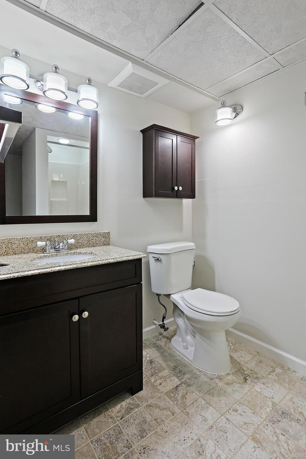 15504 Williston Road Silver Spring, MD 20905 - Photo 31 of 41 a bathroom with a toilet sink vanity and mirror