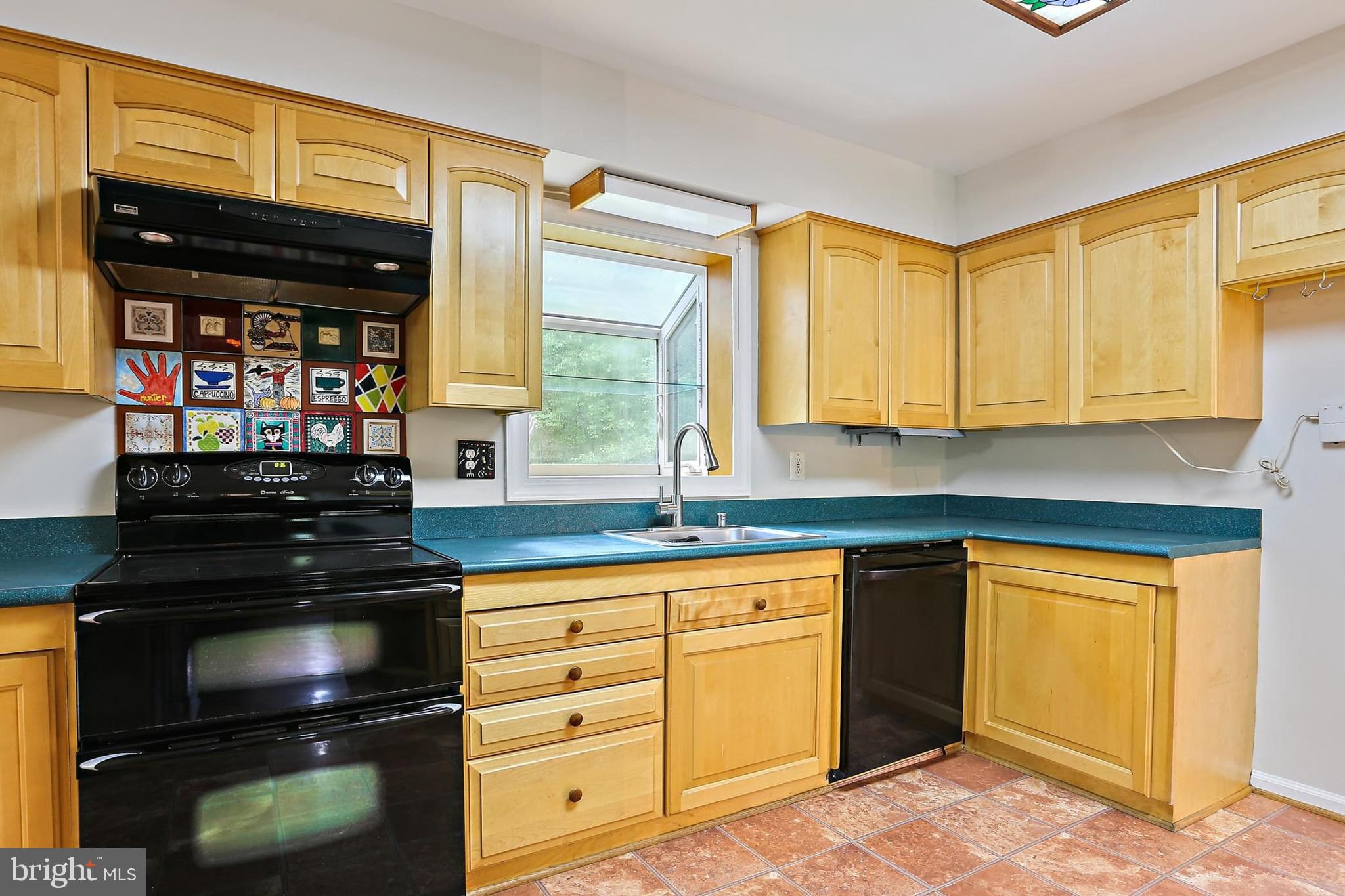 15504 Williston Road Silver Spring, MD 20905 - Photo 8 of 41 a kitchen with granite countertop a stove and a sink