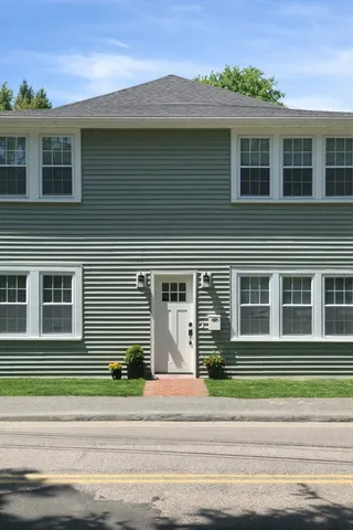 a view of a house with a flat tv screen and a floor to ceiling window