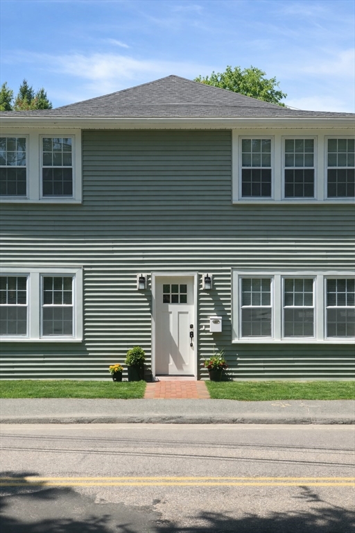 140 Ames Street, Unit 1 Sharon, MA 02067 - Photo 1 of 16 a view of a house with a flat tv screen and a floor to ceiling window