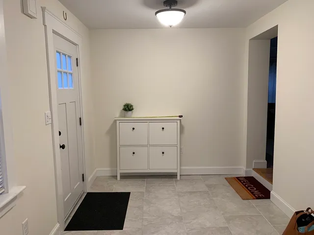 a view of a closet with wooden floor