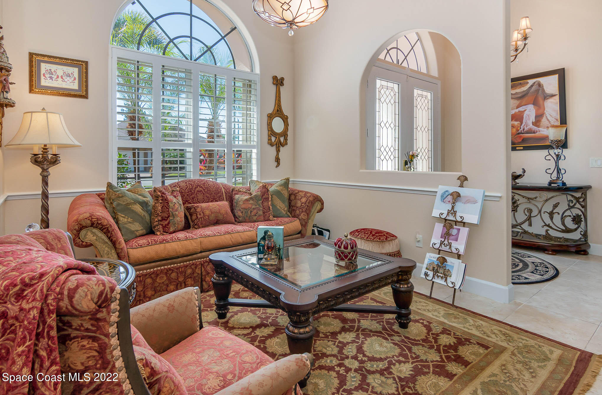 1338 Centennial Way Rockledge, FL 32955 - Photo 14 of 46 a living room with furniture a table and a large window