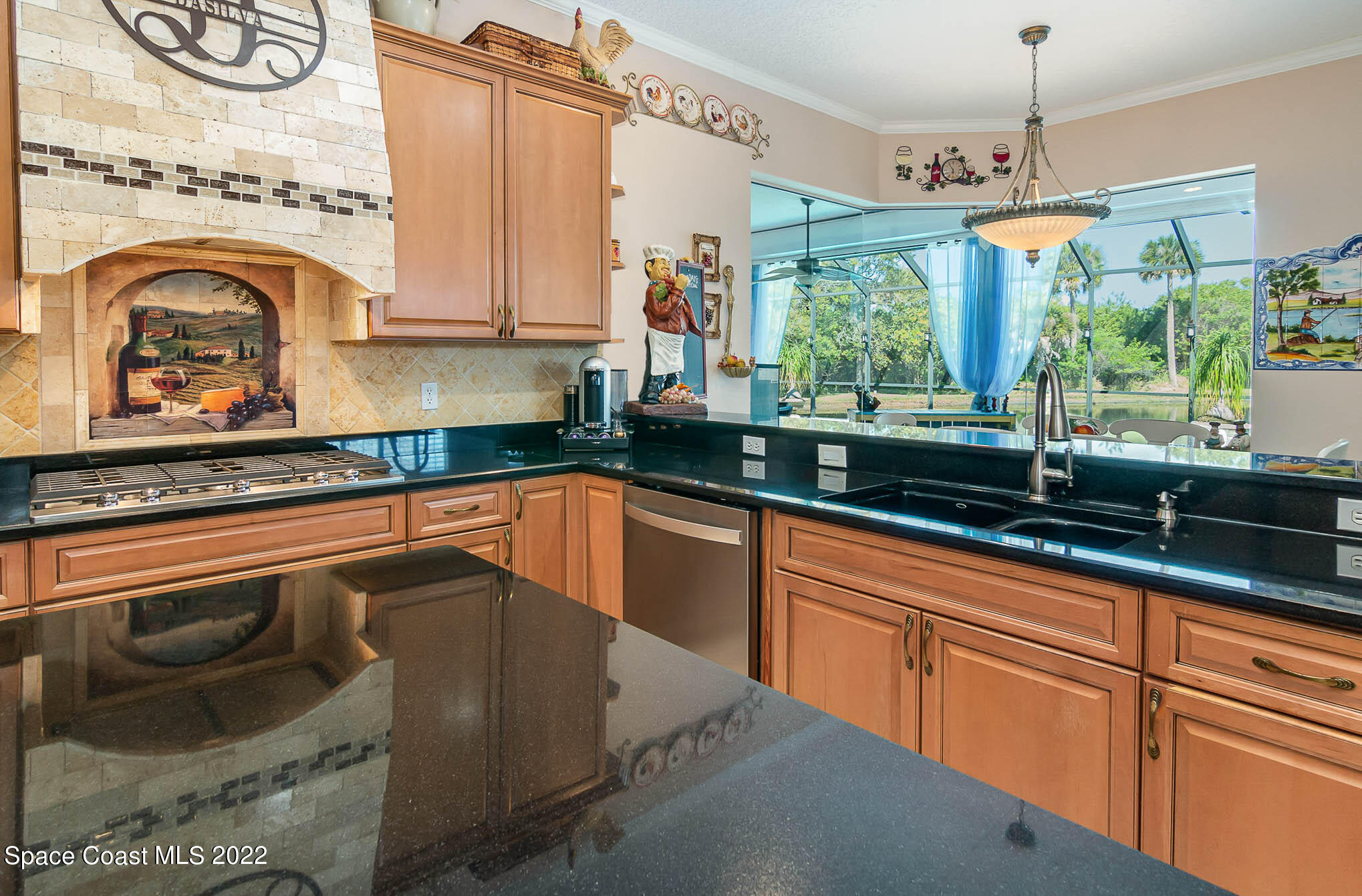 1338 Centennial Way Rockledge, FL 32955 - Photo 15 of 46 a kitchen with stainless steel appliances granite countertop a sink a stove and a granite counter tops
