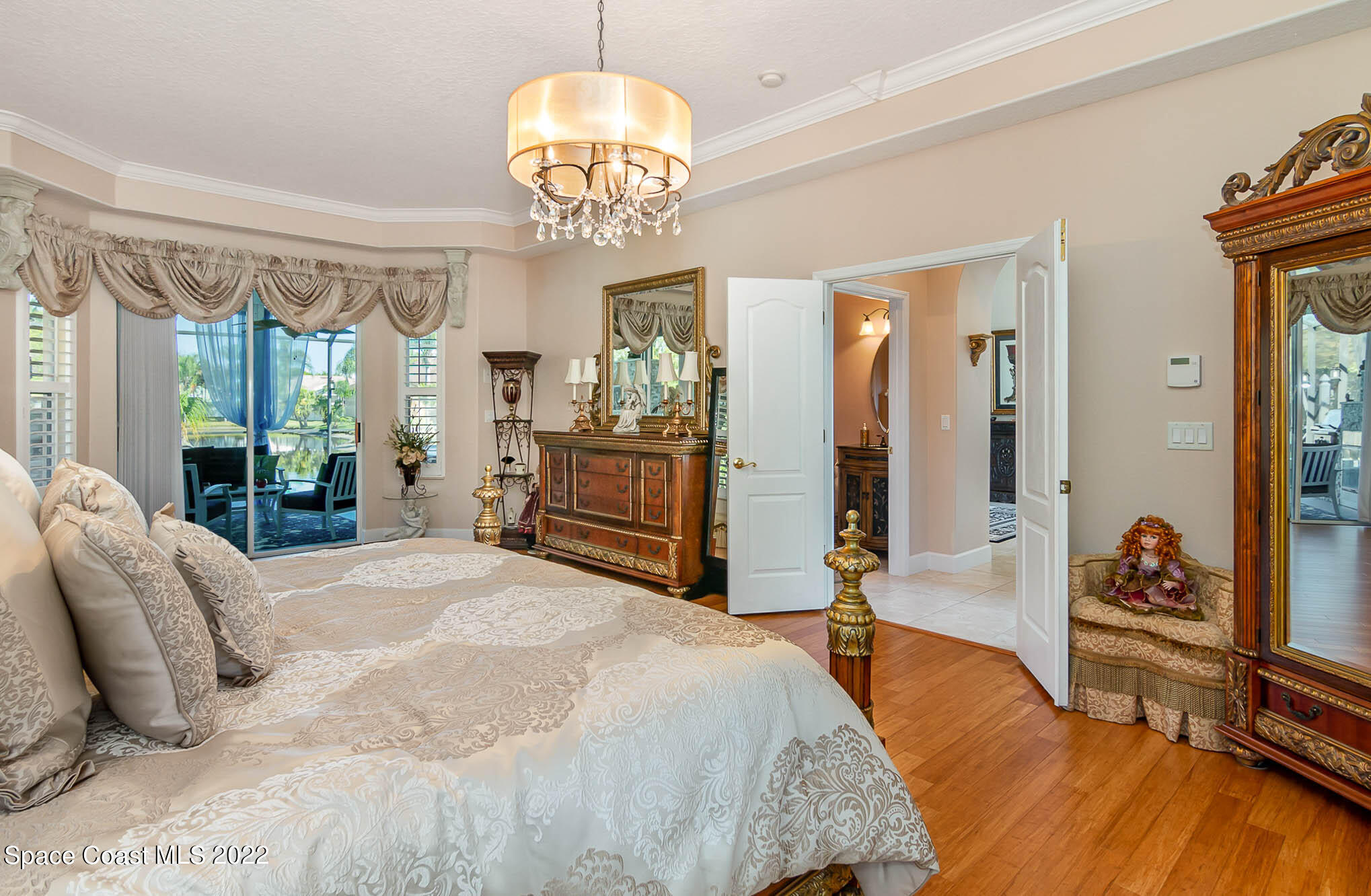 1338 Centennial Way Rockledge, FL 32955 - Photo 21 of 46 a spacious bedroom with a large bed and a chandelier