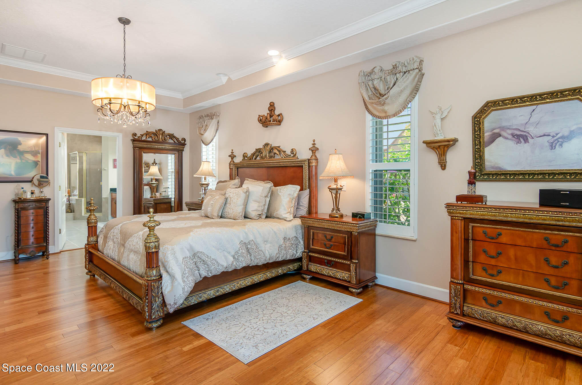1338 Centennial Way Rockledge, FL 32955 - Photo 22 of 46 a spacious bedroom with a bed and a chandelier