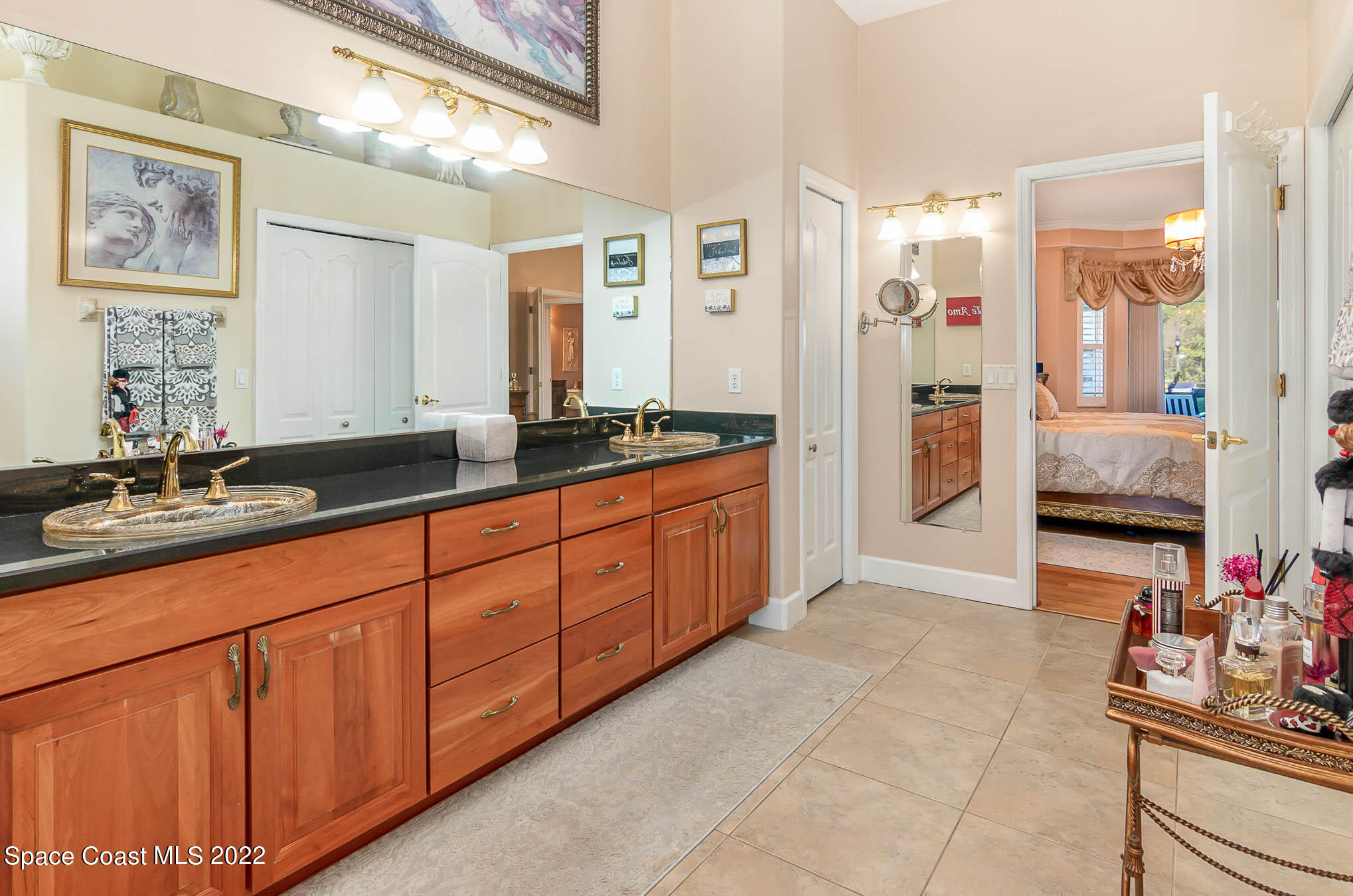 1338 Centennial Way Rockledge, FL 32955 - Photo 26 of 46 a spacious bathroom with a granite countertop sink and a mirror