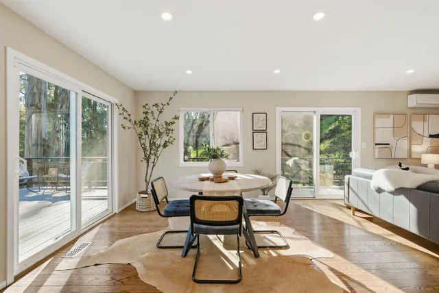 a living room with furniture and a floor to ceiling window