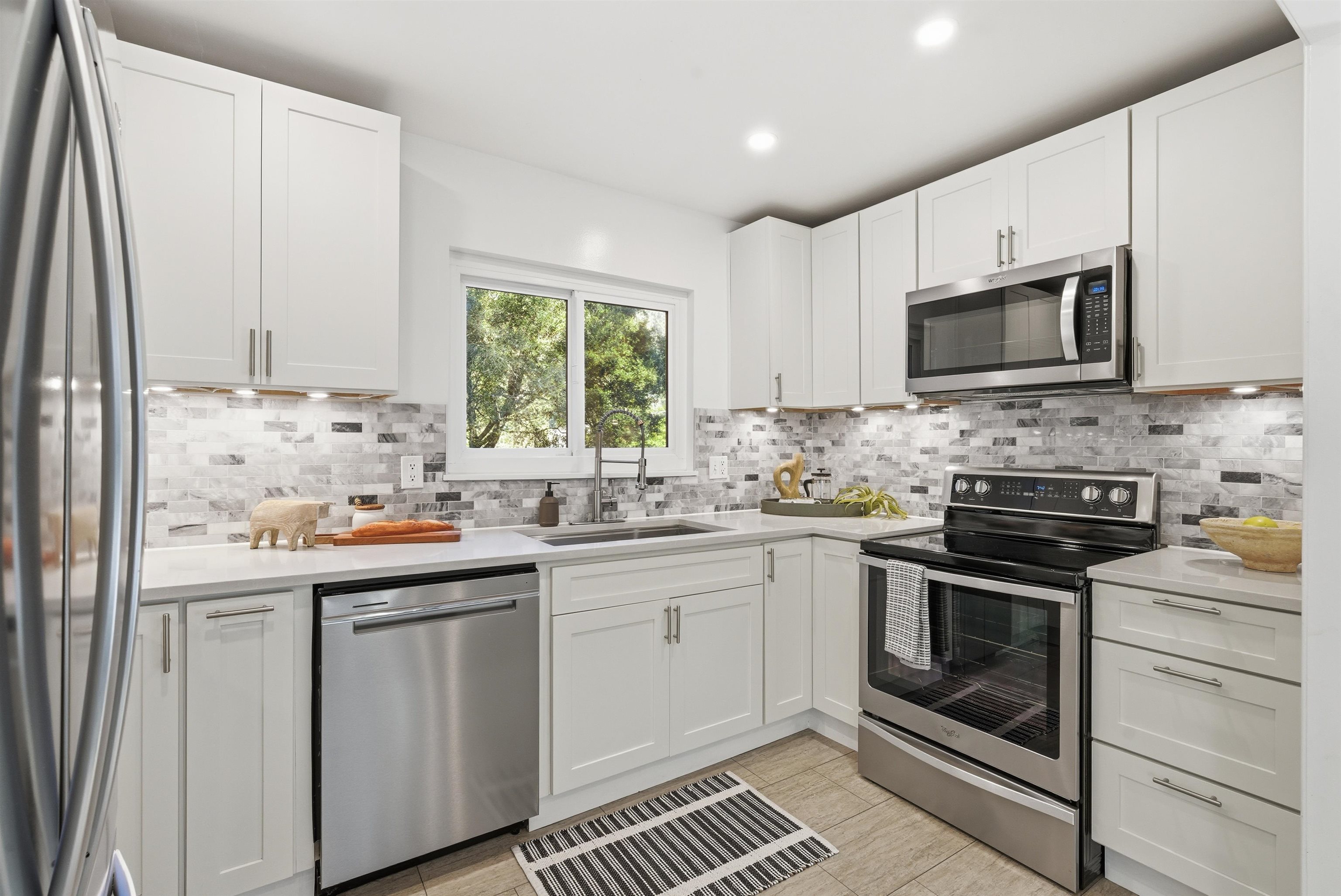 6416 Valley View Road Oakland, CA 94611 - Photo 16 of 58 a kitchen with stainless steel appliances a stove sink microwave and cabinets