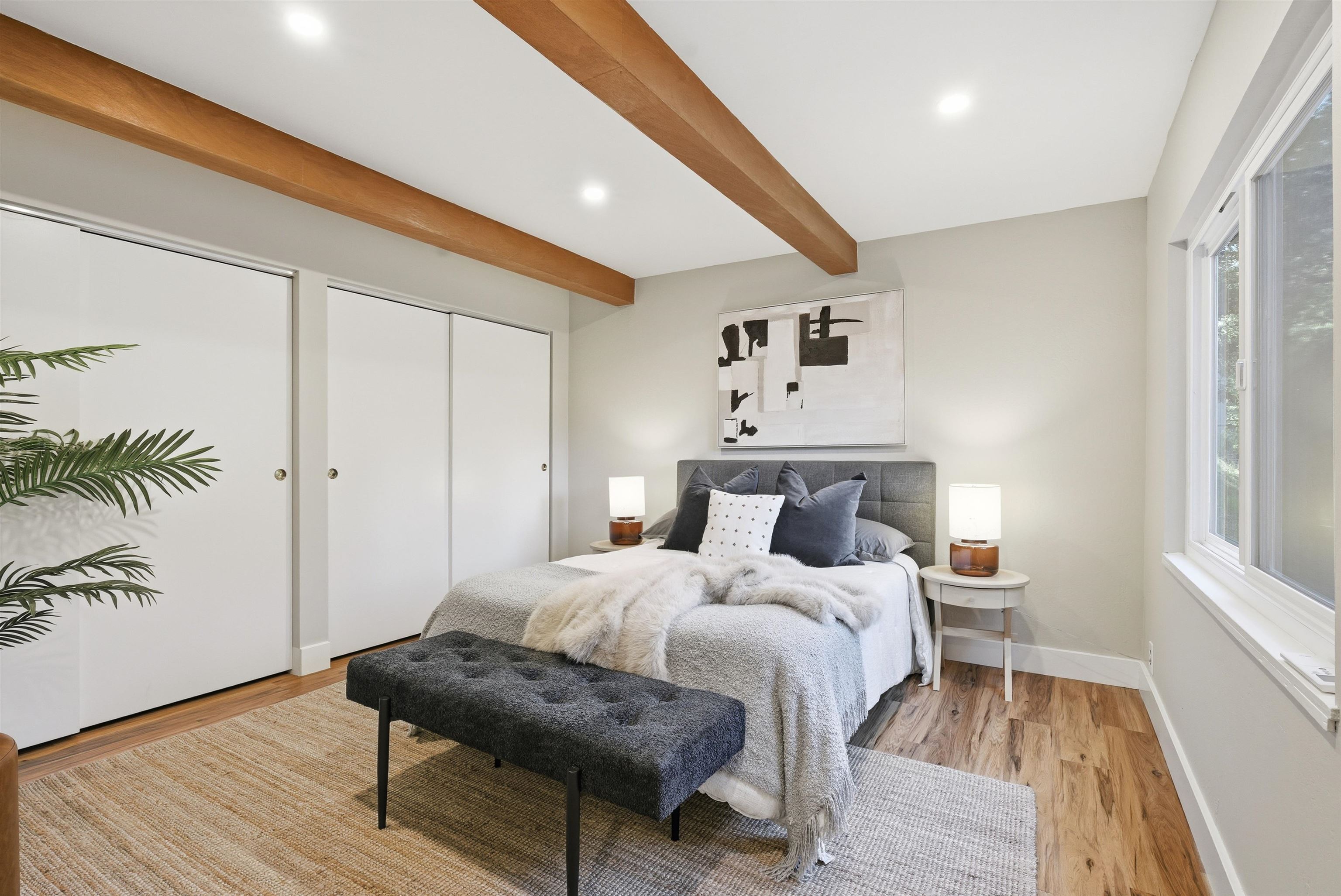 6416 Valley View Road Oakland, CA 94611 - Photo 19 of 58 a bedroom with a bed and a wooden floor