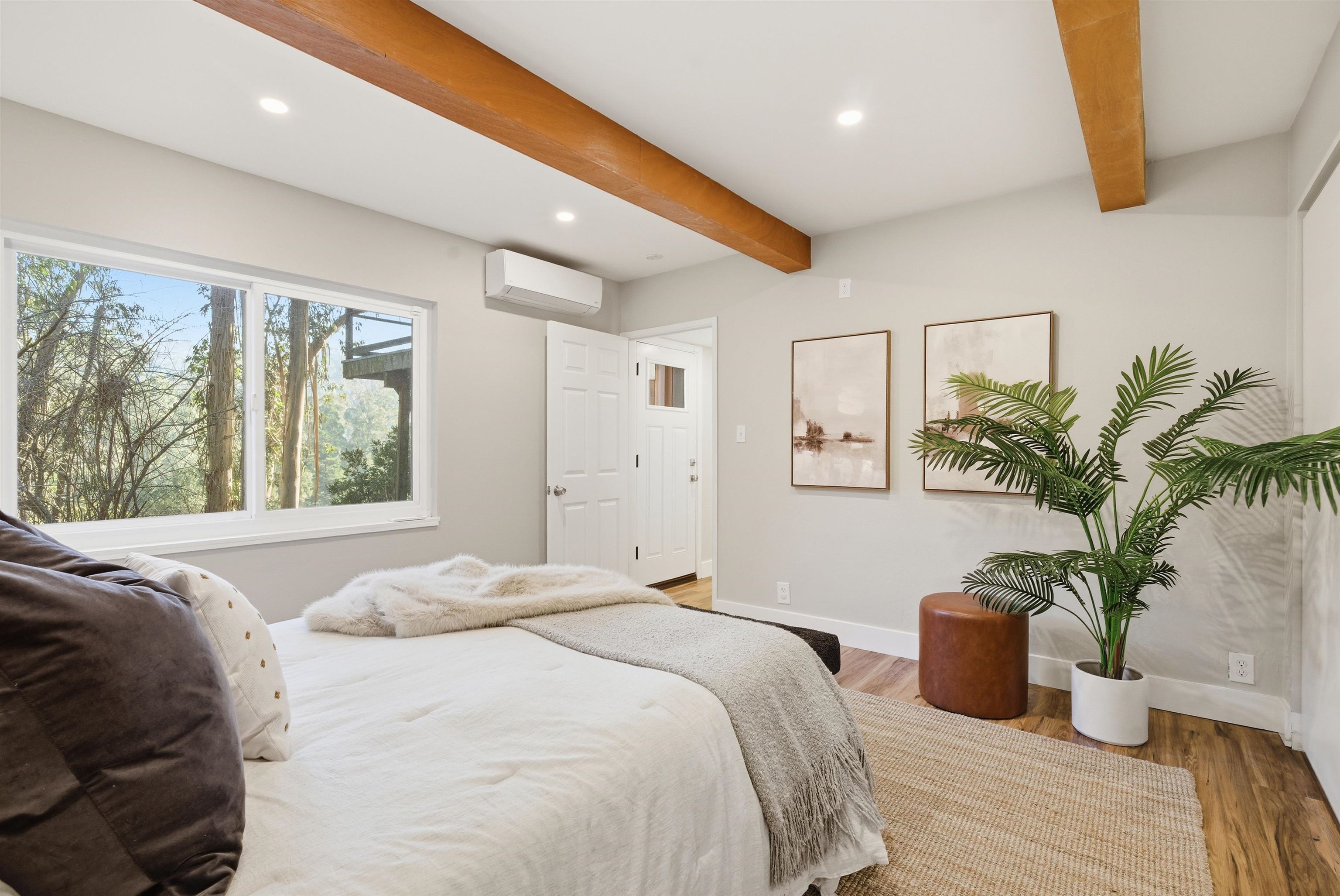 6416 Valley View Road Oakland, CA 94611 - Photo 20 of 58 a bedroom with a large bed and potted plant