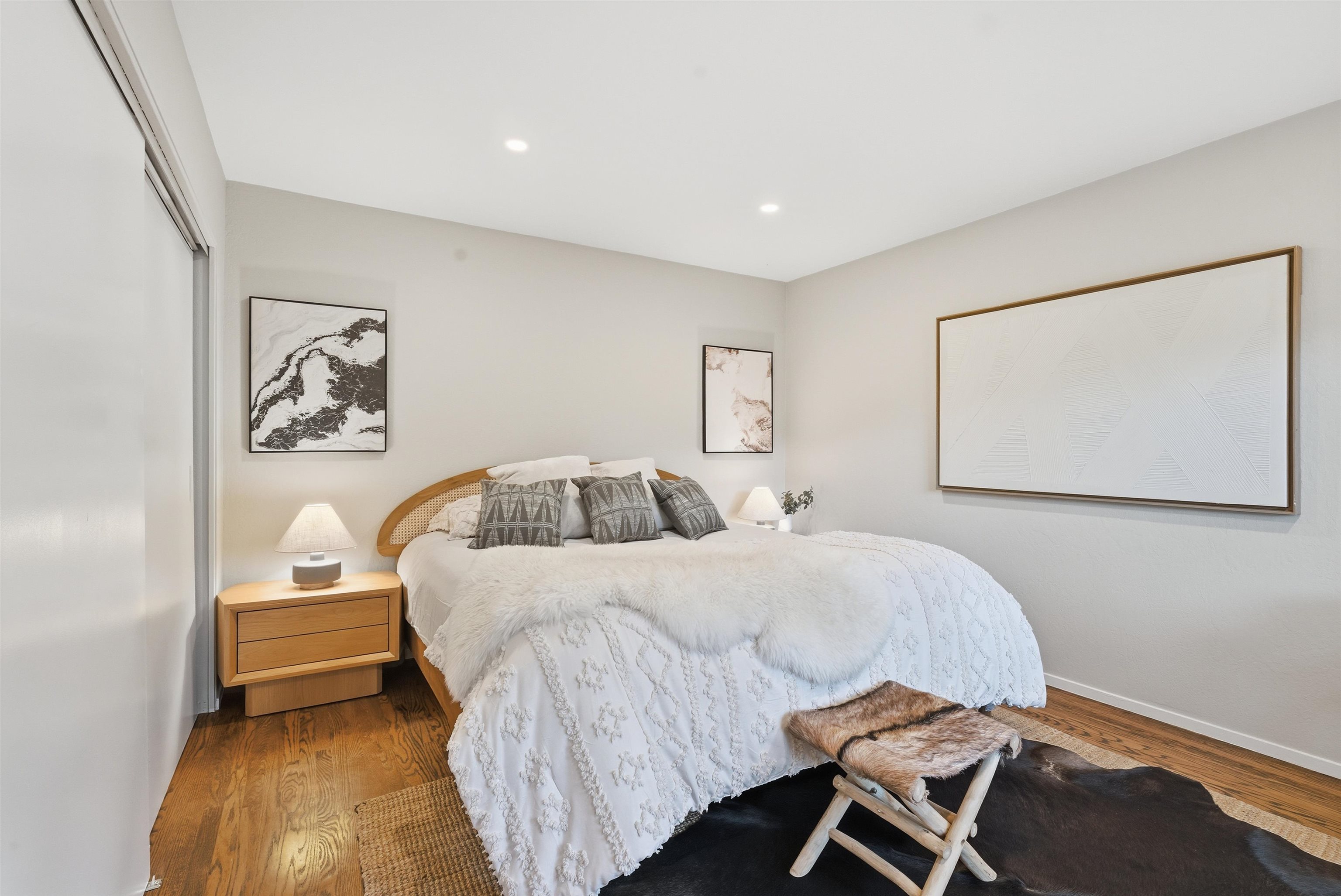 6416 Valley View Road Oakland, CA 94611 - Photo 21 of 58 a bedroom with a bed and a painting on the wall